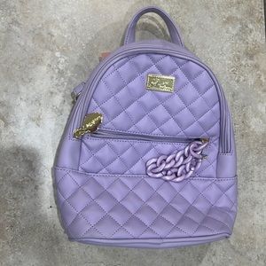 Brand new, never used small leather purple backpack.